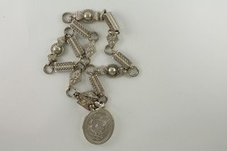 A Victorian silver locket hung a white metal collar