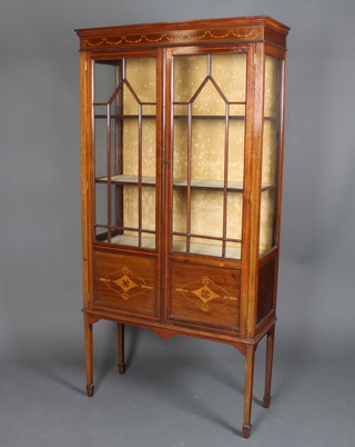 An Edwardian inlaid mahogany display cabinet fitted shelves  enclosed by astragal glazed panelled doors raised on square  tapering supports ending in spade feet 68"h x 34"w x 13"d