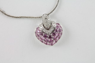 An 18ct white gold chain hung an 18ct gold pendant set diamonds and pink sapphires