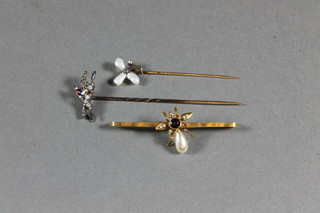 A 19th Century stick pin the in form of a race horse with jockey  up set diamonds, a pearl tie pin initialled AB and 1 other pearl  stick pin