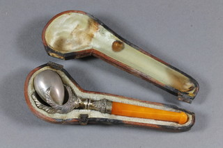 A Continental silver and amber mounted cheroot holder in the form of a claw, cased