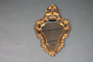 A carved gilt wood cartouche wall mirror in the Louis XV style decorated acanthus leaves and C scrolls 28"h x 17"w