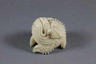 A Japanese carved ivory figure of a fishes mask? 1"