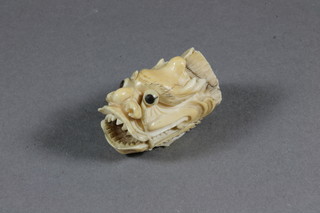 A Japanese carved ivory figure of a dragons mask with open  mouth 1.5"
