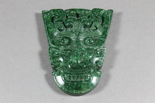 A section of green hardstone in the form of a mask 3"