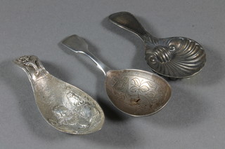 A Victorian silver fiddle pattern caddy spoon, London 1884 an embossed Continental caddy spoon and a shell shaped caddy  spoon
