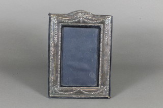 A modern embossed silver easel photograph frame 7.5" x 5.5"