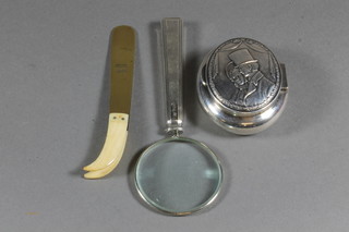 A silver handled magnifying glass, an oval embossed WMF pill box a pair of brass tweezers by A H Allen & Sons