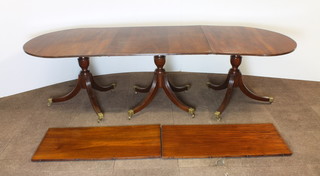 A Georgian style mahogany triple pillar D end extending dining table with 2 extra leaves, 30"h, when closed 107"l, when extended 146"l