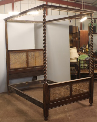 A beech and walnut four poster bed, with spiral columns and  cane panels 87"h x 81"l x 54"w