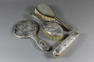 A silver backed clothes brush and a 3 piece silver backed  dressing table set