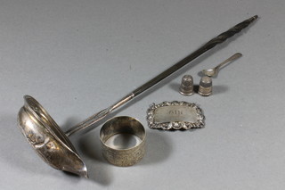 A Georgian silver oval toddy ladle with whalebone twist handle, ladle patched, a silver napkin ring, a silver decanter label