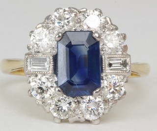 An 18ct yellow gold dress ring set a rectangular cut sapphire supported by diamonds approx 1.50/1.20ct   ILLUSTRATED