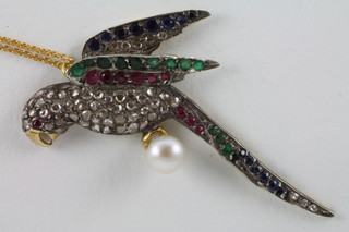 A gold pendant in the form of a parrot set diamonds, emeralds  and sapphires