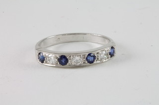 An 18ct white gold sapphire and diamond half eternity ring