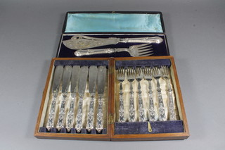 A pair of silver plated fish servers, cased and a set of 6 silver handled fish knives and forks, cased