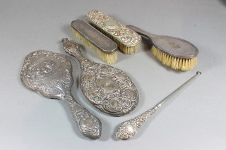 2 silver backed hand mirrors, a silver backed hair brush, a silver backed clothes brush, 1 other clothes brush and a button hook