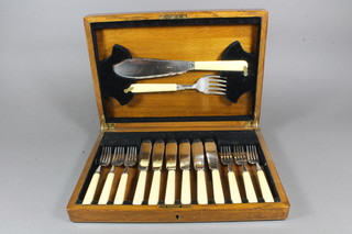A set of 6 silver plated fish knives and forks complete with  servers in an oak canteen box