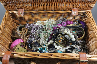 A picnic hamper containing a collection of costume jewellery