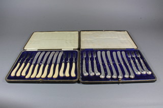 A set of 6 fruit knives with silver pistol grip handles Sheffield  1904, cased and a set of 6 fruit knives and forks with silver  bands, cased