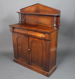A Victorian rosewood chiffonier the raised back fitted a shelf above 1 long drawer, the base fitted a cupboard enclosed by  arched panelled doors, raised on a platform base 57"h x 42"w x  16"d