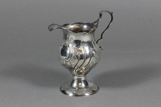 An antique embossed silver cream jug 2 ozs