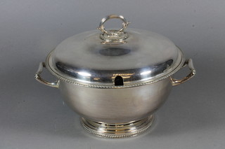 A circular silver plated soup tureen and cover with ladle 9"