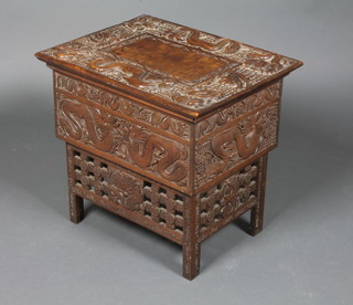 An Oriental rectangular carved hardwood table with hinged lid, heavily carved dragons throughout, 18"h x 19"w x 15"d