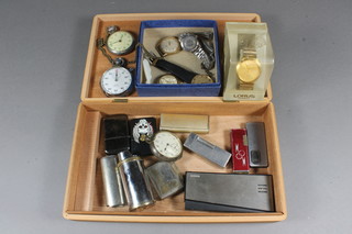 A collection of pocket watches and lighters