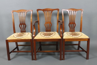 A set of 8 mahogany Chippendale style slat back dining chairs, 2 with arms, having upholstered drop in seats on square tapering supports with H framed stretcher