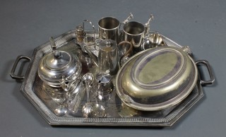 A silver plated twin handled tea tray, an entree dish and a small collection of plated items