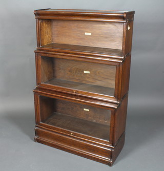 An oak 3 tier Globe Wernicke bookcase, the upper section with glazed panelled door 53"h x 34"w x 14"d