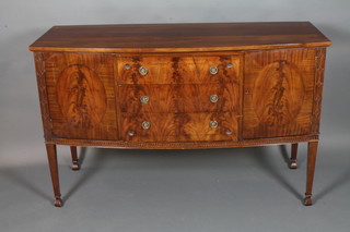 A Georgian style mahogany bow front sideboard fitted 3 long drawers flanked by a pair of double cupboards and with blind fret  work decoration to the side, raised on square tapering supports,  spade feet, 38"h x 60"w x 23d