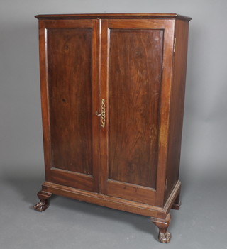A 19th Century mahogany cabinet, fitted shelves enclosed by  panelled doors, raised on cabriole ball and claw feet, 55"h x  36"w x 18"d