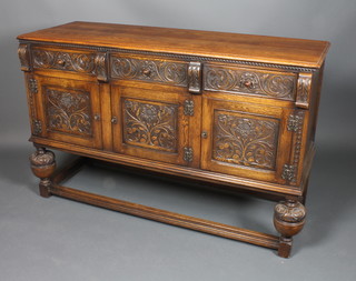 A 17th Century style carved oak dresser base fitted 3 drawers  above a triple cupboard raised on bulbous turned supports with  box framed stretcher 37"h x 58"w x 20"d