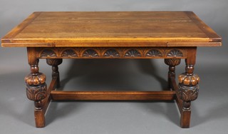 A 17th Century style oak drawleaf dining table raised on 4  bulbous turned supports with H framed stretcher, raised on  turned and block supports 29" x 59" x 26"