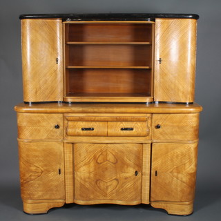 A French Art Deco elm dresser with raised back fitted shelves,  flanked by a pair of cupboards enclosed by panelled doors, the  base fitted a brushing slide above 2 short drawers and double  cupboard flanked by 2 cupboards above cupboards 96"h x 63"w x  21"d