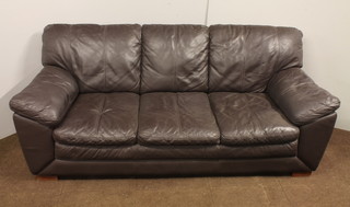 A 3 seat sofa upholstered in brown leather 34"h x 81"w