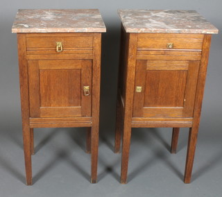 A pair of French oak bedside cabinets with veined marble tops fitted a drawer above a double cupboard, raised on square  tapering supports 32"h x 16"w x 14"d