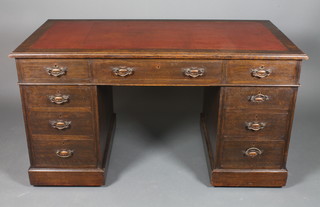 An Edwardian Art Nouveau oak pedestal desk with brown leather  skiver fitted 1 long and 8 short drawers 30"h x 54"w x 28"d