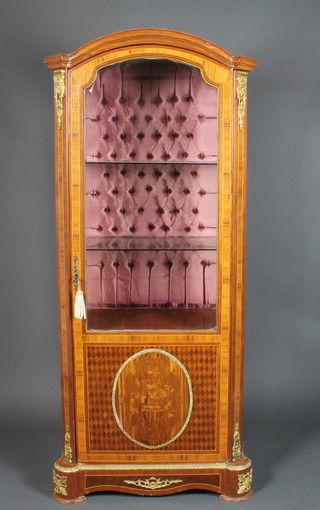 A 20th Century Kingwood arch shaped vitrene, fitted shelves  enclosed by a glazed panelled door, having a marquetry panel to the base and with gilt metal embellishments 70.5"h x 31"w x 19"d  ILLUSTRATED