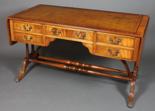 A Georgian style mahogany drop flap writing table with inset brown skiver above 1 long and 4 short drawers, raised on turned  supports on splayed legs 29.5"h x 53"w x 27"d