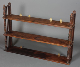 A Victorian mahogany 3 tier hanging wall shelf with turnings to  the sides 27"h x 37"w x 7"d
