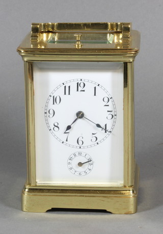A French striking carriage alarm clock with enamelled dial and Arabic numerals contained in a gilt metal case