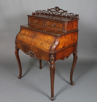 A French figured walnut bonheur du jour, the upper section with pierced and carved three-quarter gallery fitted 2 drawers, the fall  front revealing a fitted interior raised on carved cabriole supports  47"h x 31"w x 21"d