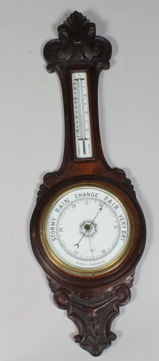 A Victorian carved mahogany aneroid wheel barometer in the  Rococo taste, fitted Arabic thermometer above an enamelled dial,  36"h x 12"
