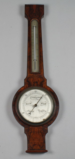 John Barker & Co. Kensington London, a late Victorian figured walnut and parcel ebonised wheel barometer, mounted  thermometer with Arabic silvered vernier scale and dial, 29"h x  9"w