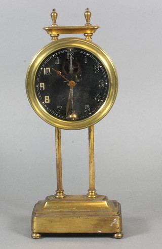 A gravity clock, the dial with Arabic numerals contained in a gilt  metal case