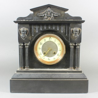A Victorian French 8 day striking mantel clock with enamelled  dial and Roman numerals contained in a black marble architectural case