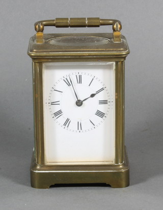 A French carriage clock with enamelled dial and Roman  numerals contained in a gilt brass case 4"